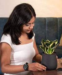 Woman holding a potted plant in a casual setting