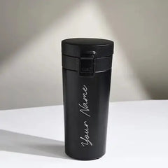 Custom name black flask with secure push button lid, perfect for keeping beverages hot or cold. Sleek design for kitchen or travel use.