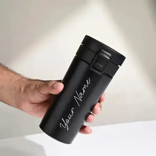 Personalised black push button flask with custom name engraving, ideal for hot or cold drinks. Vacuum insulated for everyday use.