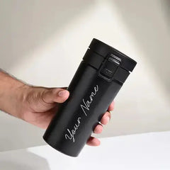 Personalised black push button flask with custom name engraving, ideal for hot or cold drinks. Vacuum insulated for everyday use.