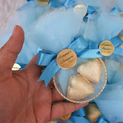 Hand holding blue Aqiqah Golden Hearts Favor with gold heart chocolates and custom engraved tag, suitable for baby gift sets.