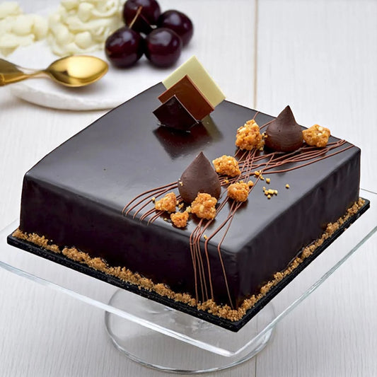 Belgium Chocolate Truffle Cake - Rich Layers with glossy truffle glaze, chocolate decor, and crunchy toppings on a square base. Ideal for birthdays or anniversaries.