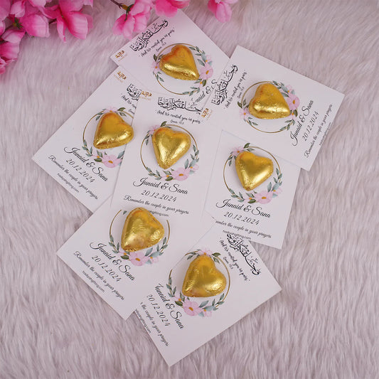 Customized chocolate wedding favors for Nikah featuring gold heart-shaped chocolates on floral cards with Islamic quotes and couple's names.