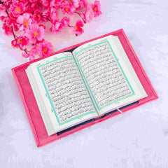 Open Quran with green border text in pink velvet cover, included in the Sawab-e-Jariya bridal gift hamper. Perfect for Nikkah gifting.