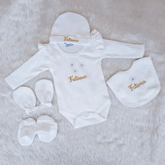 Baby clothing set with 'Fatima' embroidery on a soft surface