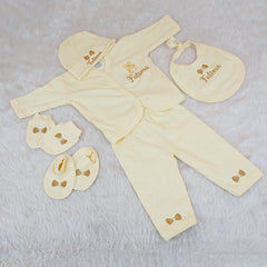 Yellow baby outfit set with matching accessories on a light gray background