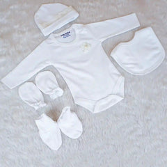 White baby outfit set with bodysuit, hat, bib, and booties on a light background