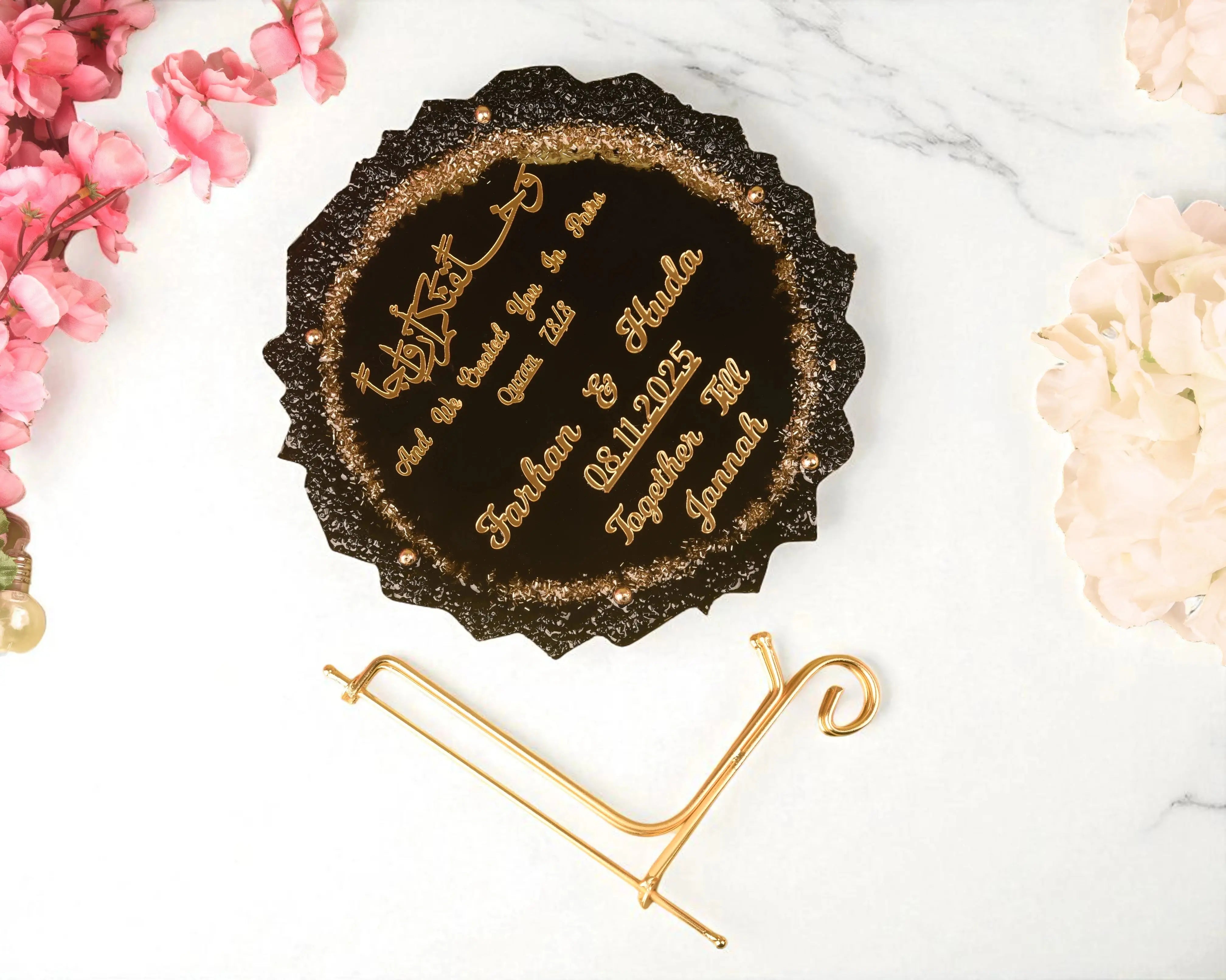Round Black Sequence Couple Frame with gold text and stand, ideal for personalized Nikah or wedding gifts, surrounded by floral accents.