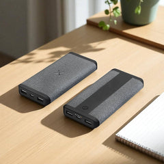 Two black power banks on a wooden surface