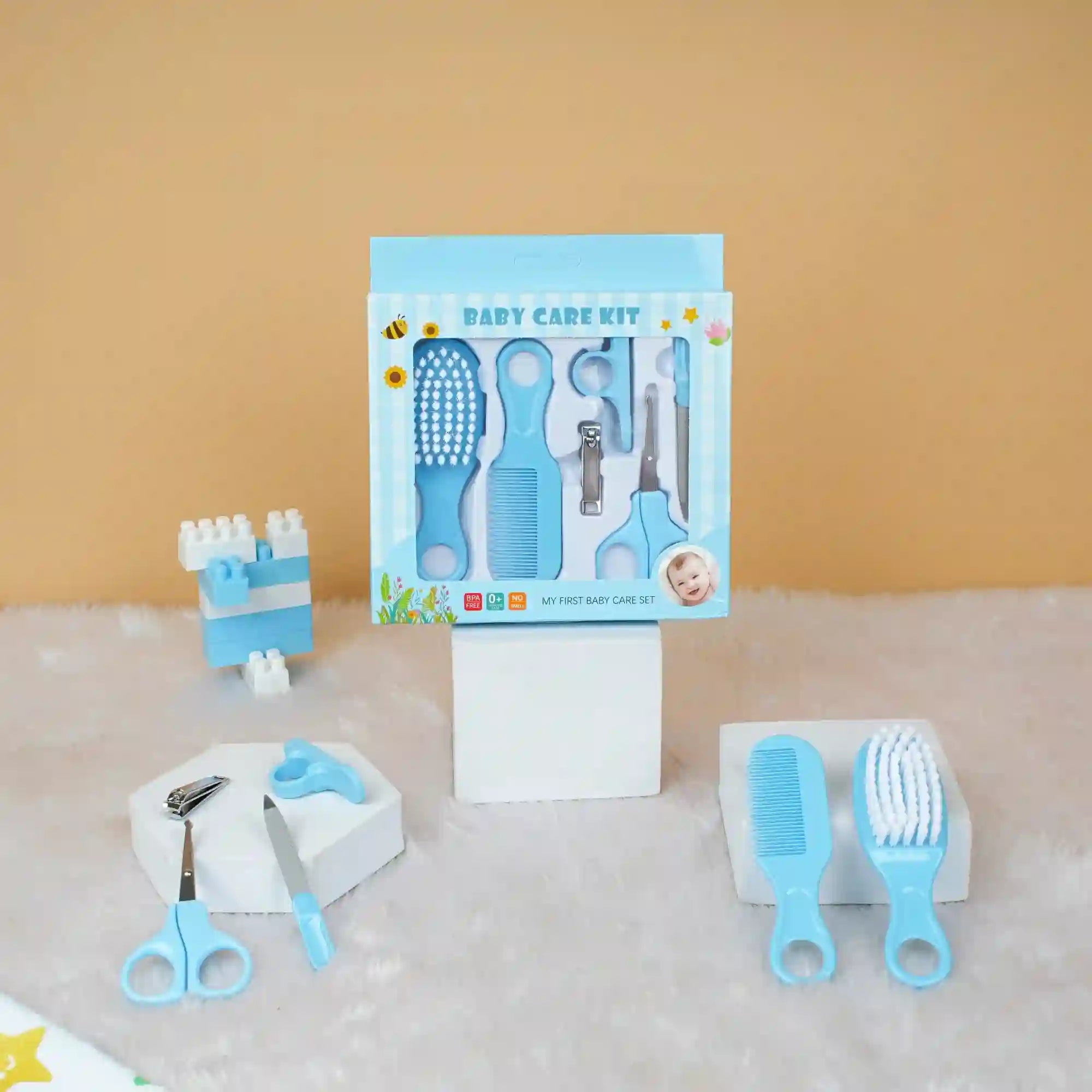 Baby care kit with tools and packaging on a textured surface