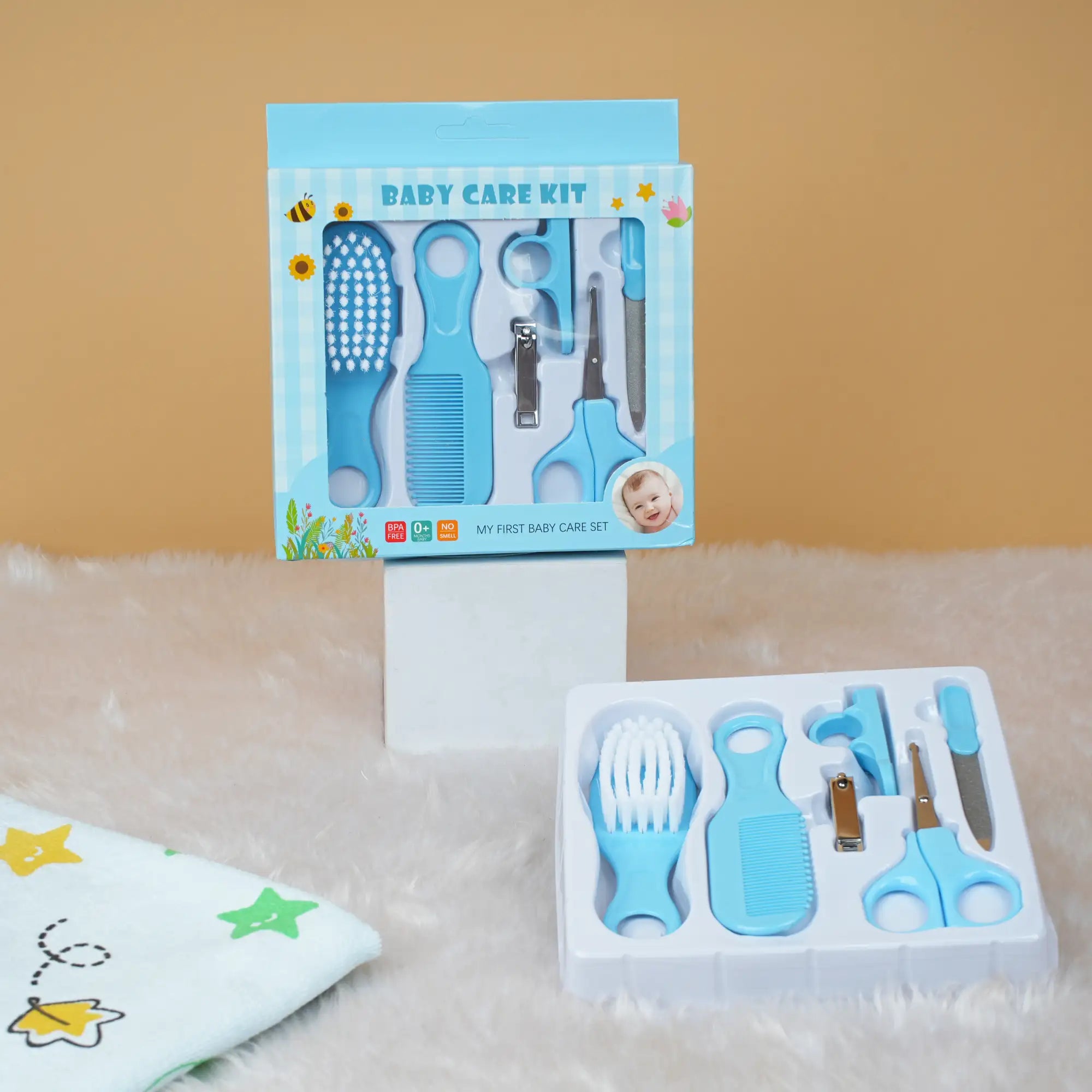 Baby care kit with tools and packaging on a beige surface
