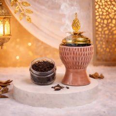 Blush Crown Bakhoor Burner with golden lid emitting aromatic smoke, ideal for Ramadan & EID home decor and gifting. Includes bakhoor jar beside it.