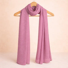 Dark pink studded hijab with smooth chiffon texture, elegantly draped on a wooden hanger. Ideal for versatile modest fashion styling.
