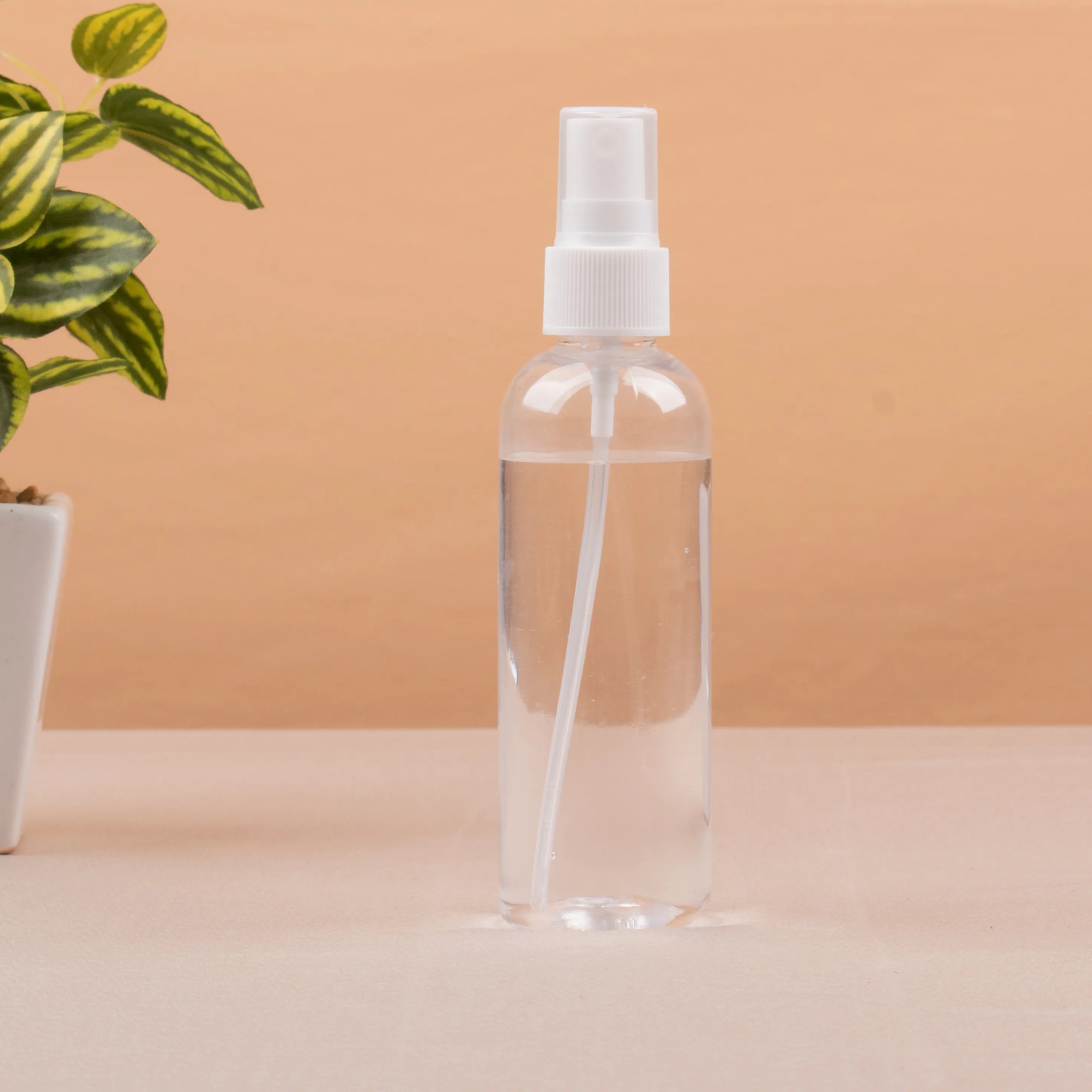 Clear spray bottle from Raah-e-Makkah Safar Essentials - Luxury Hajj Umrah Hampers, useful for personal hygiene during pilgrimage travel.