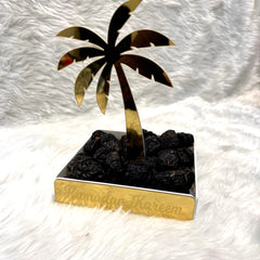 Date Tree Stand - Eid Stand Display with gold acrylic palm design, filled with dates. Features 'Ramadan Kareem' engraving, ideal for festive decor.