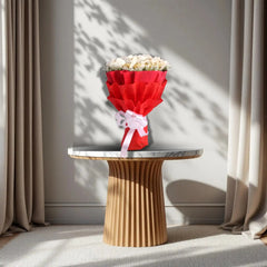 Ferrero Rocher Bunch - Chocolate Bouquet | 16 Piece Pack arranged in red paper with green fillers and white ribbon, placed on a marble-top table.