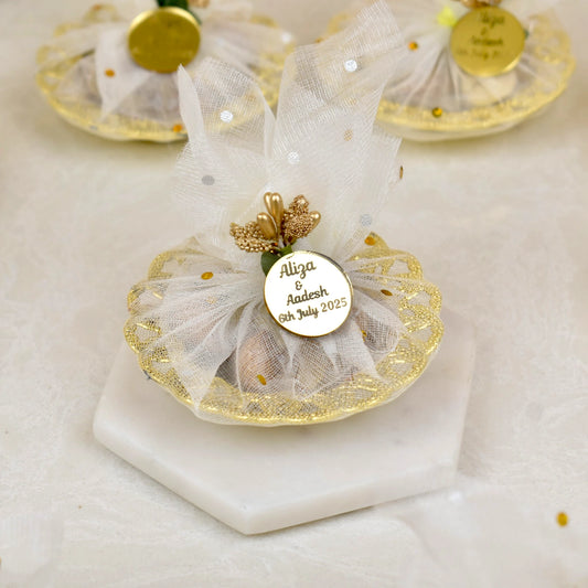 Mix Dry-Fruit Nikah Favor Gift Tray with personalized gold tag, wrapped in white net fabric and decorated with golden accents.