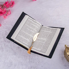Quran with English translation and golden feather bookmark from the Black Sequence Rehal Hamper - ideal for global gifting.
