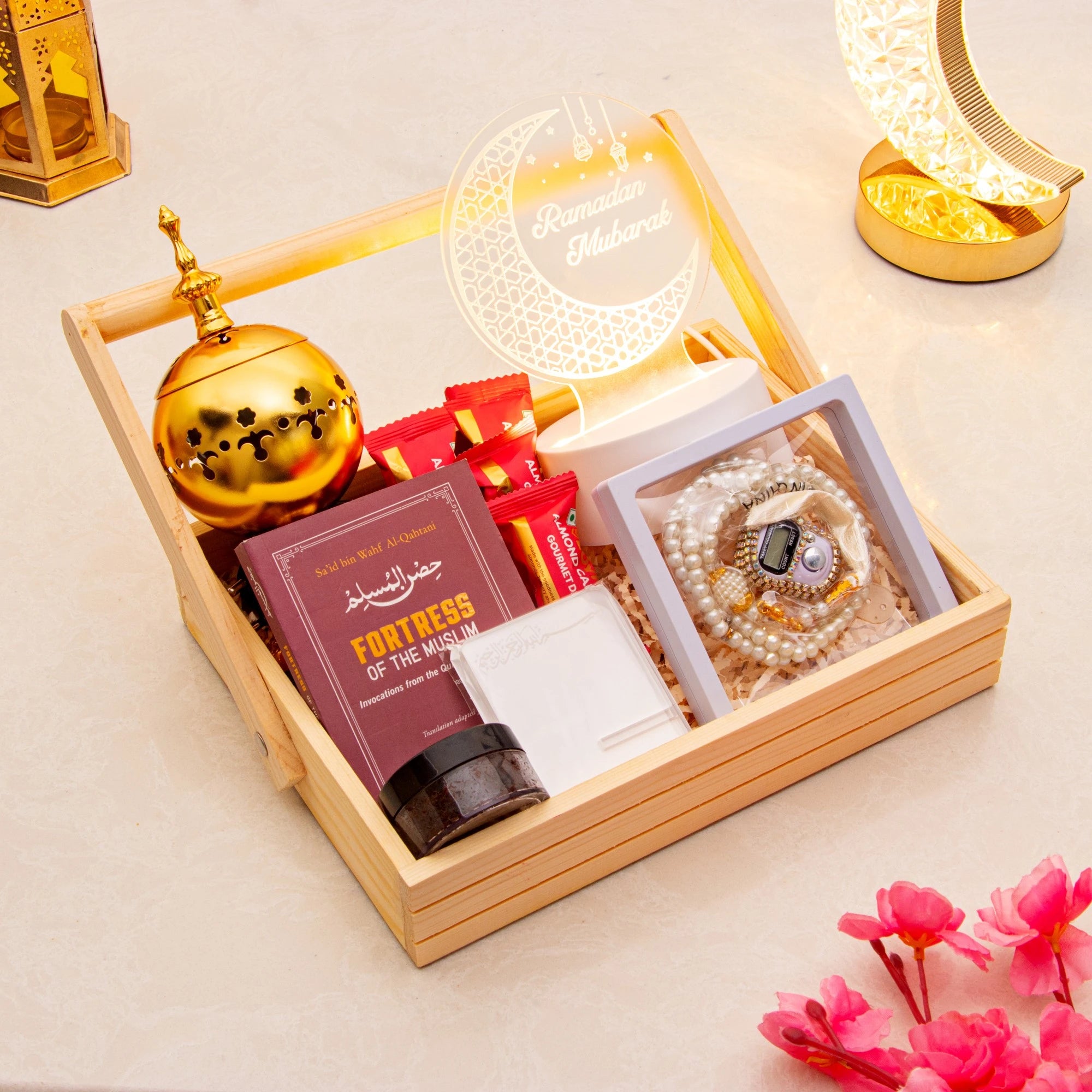 Elegant Ramadan Gift Hamper with tasbeeh, Islamic book, LED crescent lamp, and bakhoor in a wooden crate for spiritual reflection.