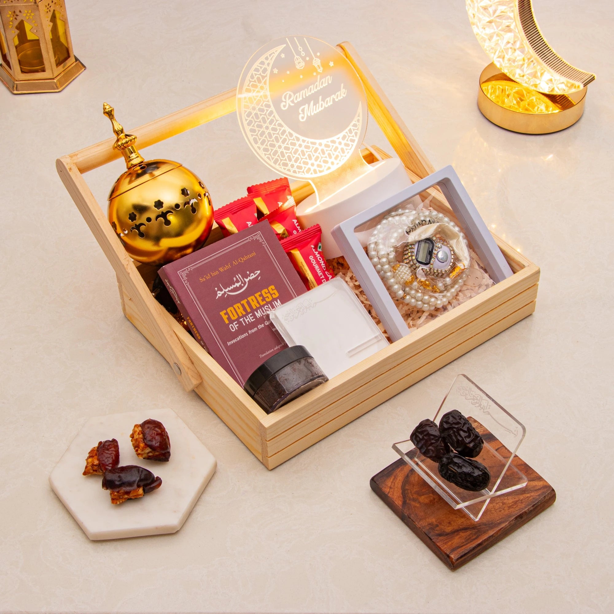 Dua and Barkat Ramadan Gift Set with tasbeeh, LED Ramadan Mubarak lamp, bakhoor burner, dates, and Islamic book in a wooden box.
