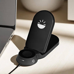 Flare Dock 3 in 1 Wireless Charger with sleek black design, positioned near a laptop, ready to charge multiple devices simultaneously.