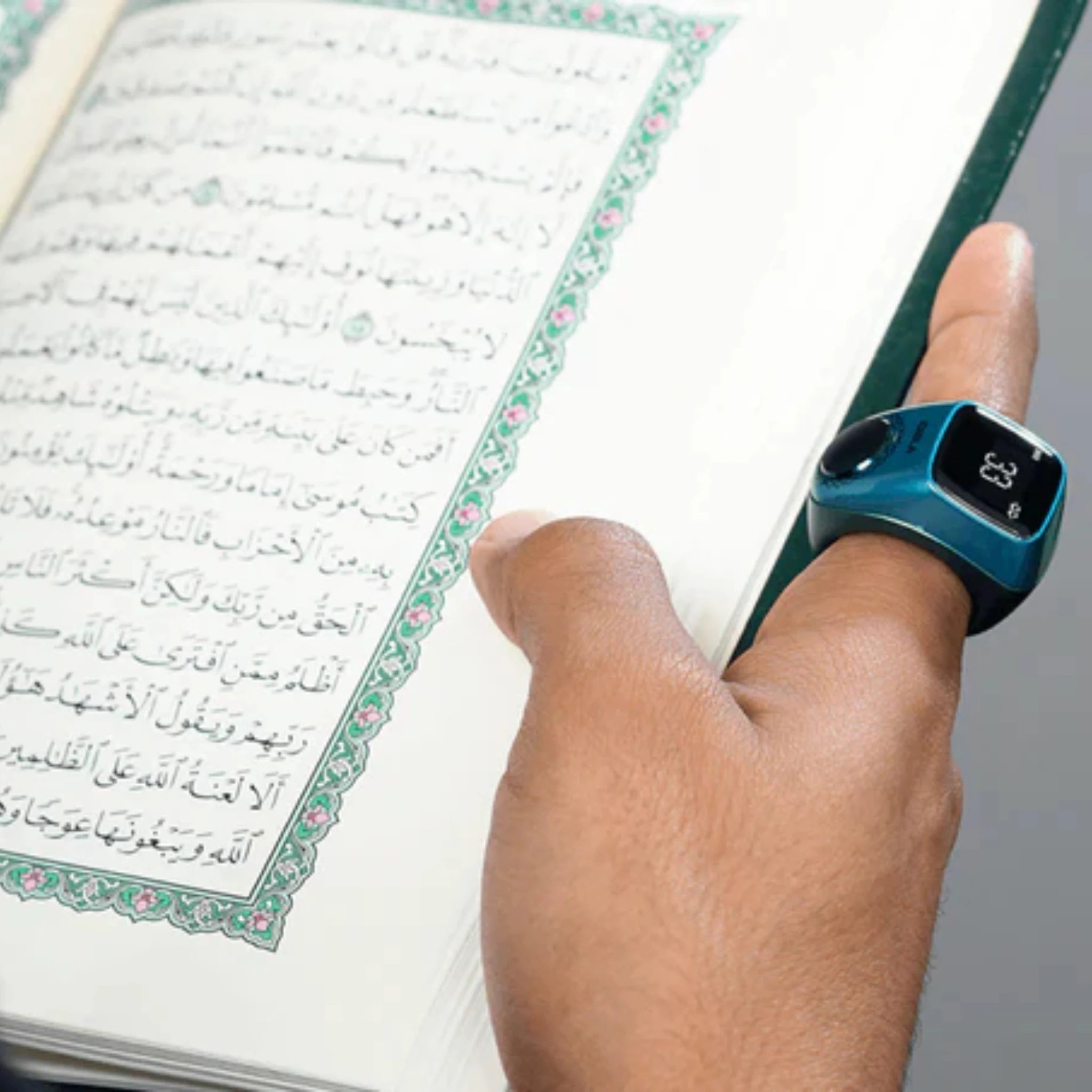Smart Zikr Ring Flex Pro worn during Quran reading, ideal for tasbih counting and prayer tracking in Islamic rituals.