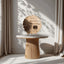 Decorative wooden plaque on a marble table with curtains in the background