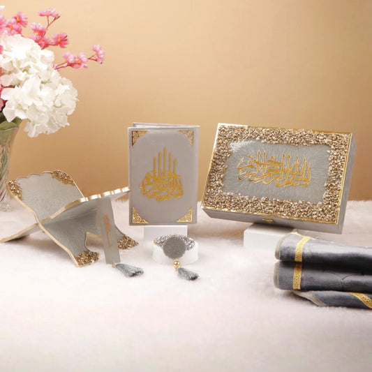 Grey Stones Sawab-E-Jariya Gift Hamper featuring premium Quran, Rehal, tasbih, bookmark, and prayer mat in elegant gold and grey design.