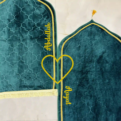 Personalized Couple Prayer Mat Duo featuring Green Dome shape and yellow heart, names 'Abdullah' and 'Ayat' stitched, perfect for gifting.