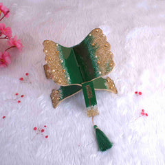Glittered green and gold Quran rehal from Kids Islamic Gift Hamper. Decorative and functional for young children’s religious use.