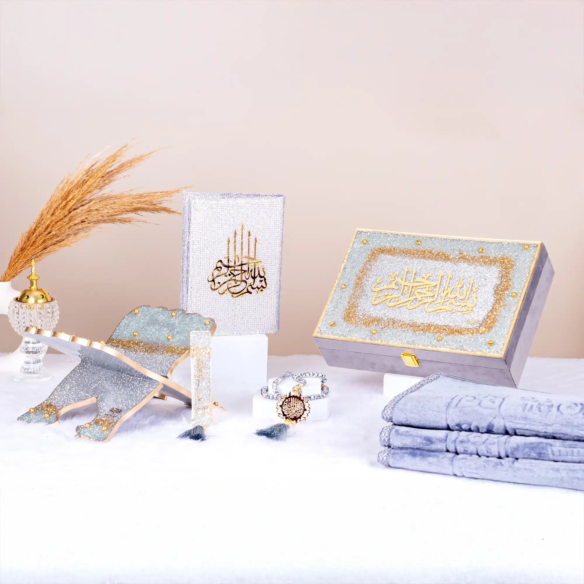 Silver Sawab-e-Jariya Gift Set from The Bling Collection featuring Quran, Rehal, Tasbeeh, and prayer mat. Ideal for Eid and wedding gifting.