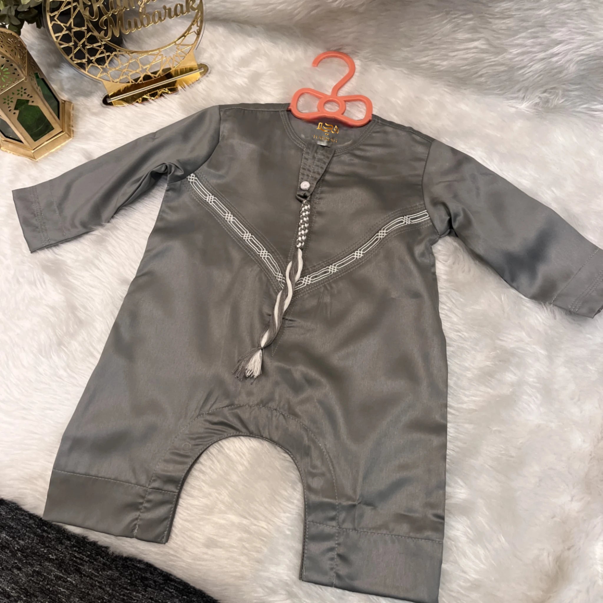 Grey Thobe Romper for Baby Boys in Omani style with tassel detail, ideal for Ramadan and Eid celebrations. Made from soft, breathable fabric.