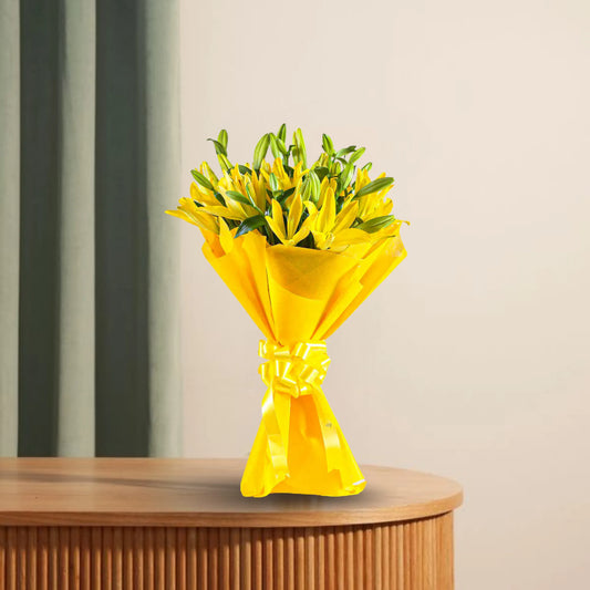 Asiatic Lilies Bunch - Lovely Flowers wrapped in vibrant yellow paper, placed on a wooden table. Fresh blooms ideal for gifts or decor.