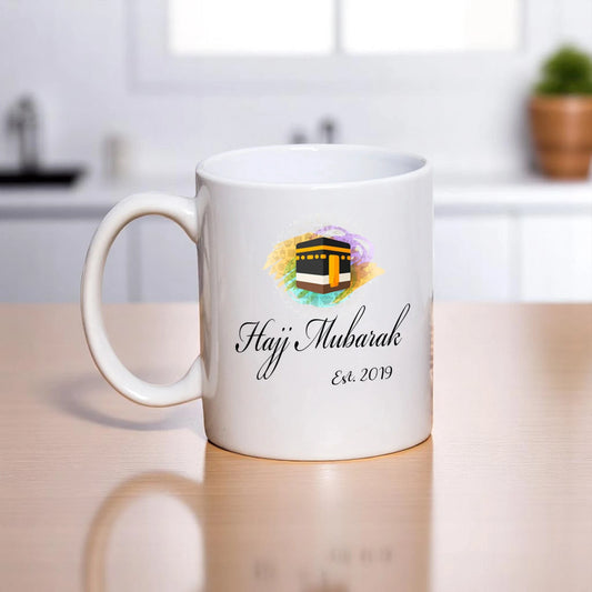 Personalized Hajj Mubarak Mug - Welcome Back design with Kaaba illustration and 'Hajj Mubarak Est. 2019' text on white ceramic, 350ml mug.