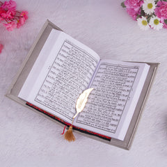 Open Holy Quran with Hindi translation and golden feather bookmark from the Velvet Quran Rehal Hamper. Inclusive religious gift for diverse readers.