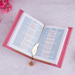 Open pink velvet Quran with Urdu translation and golden feather bookmark. Included in the Pink Bridal Hamper for spiritual gifting.