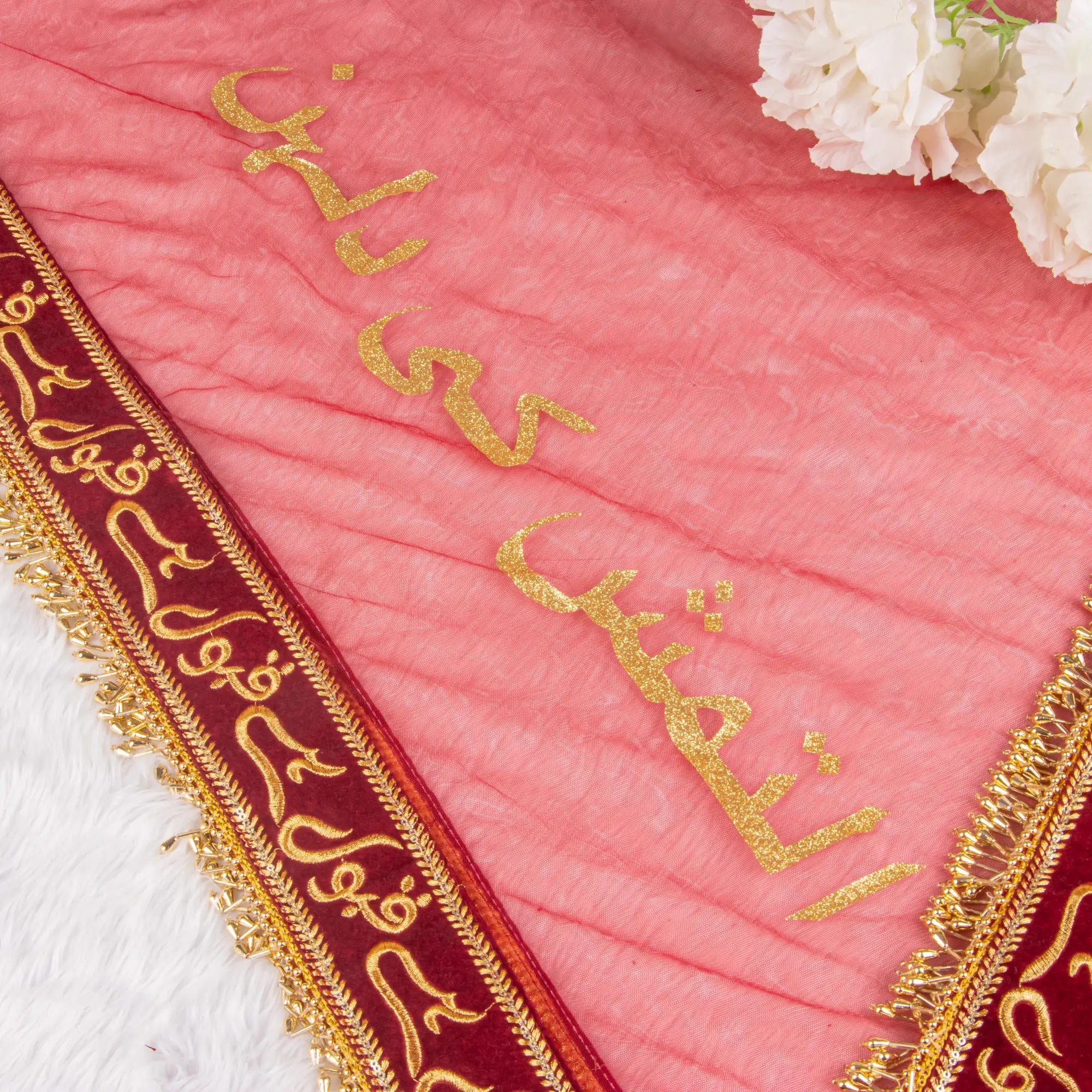 Close-up of pink bridal dupatta with golden Urdu script and maroon border from Amaanat-e-Nikaah Bridal Bling Collection.
