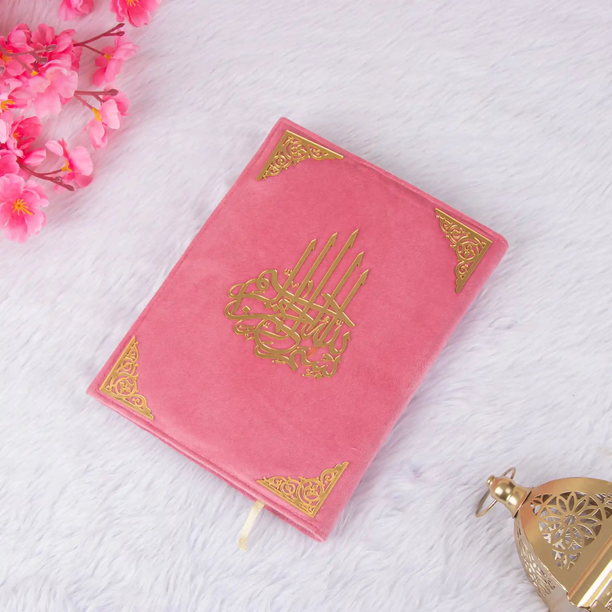 Custom Pink Salah Hamper Quran with gold detailing, placed on white fur with lantern. Elegant and meaningful prayer gift set.
