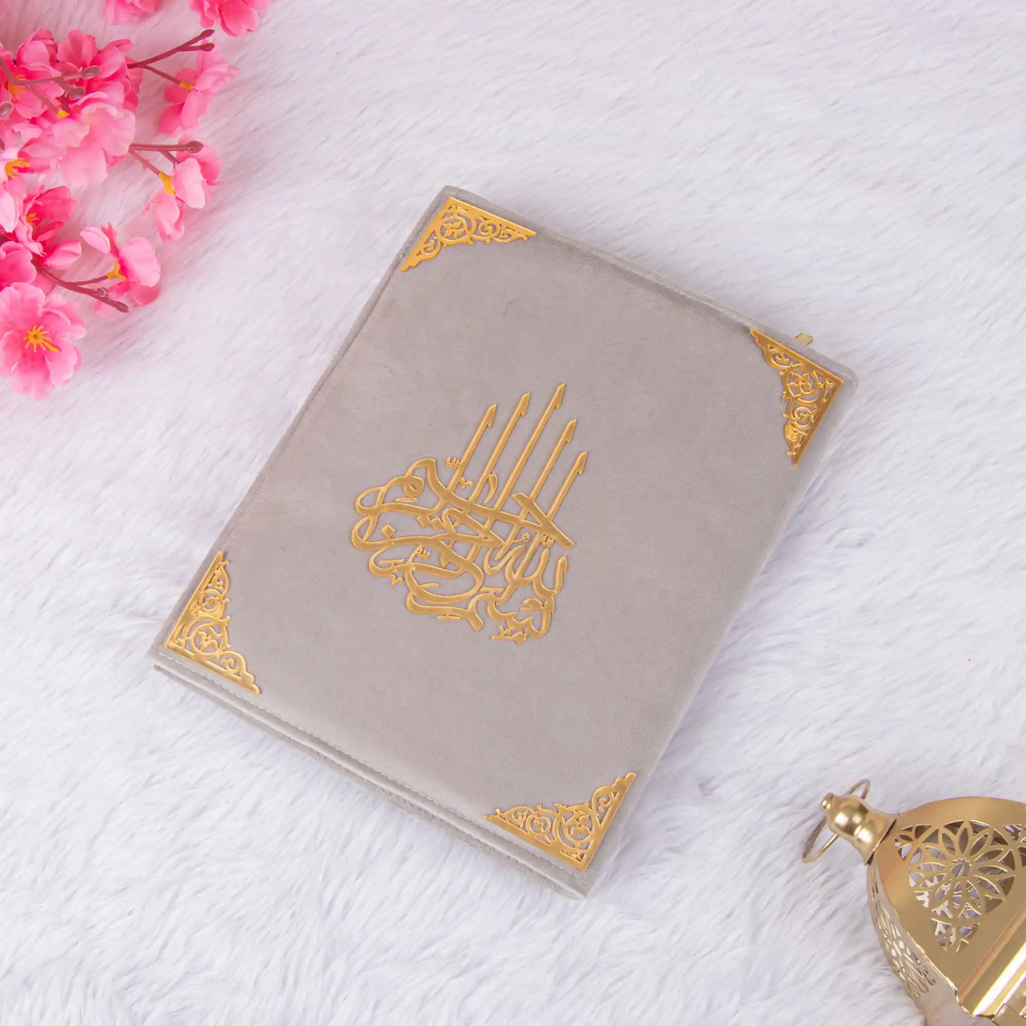 Flat-lay of grey velvet Quran with gold detailing from the Customised Grey Salah Combo Hamper, ideal for religious gifting.