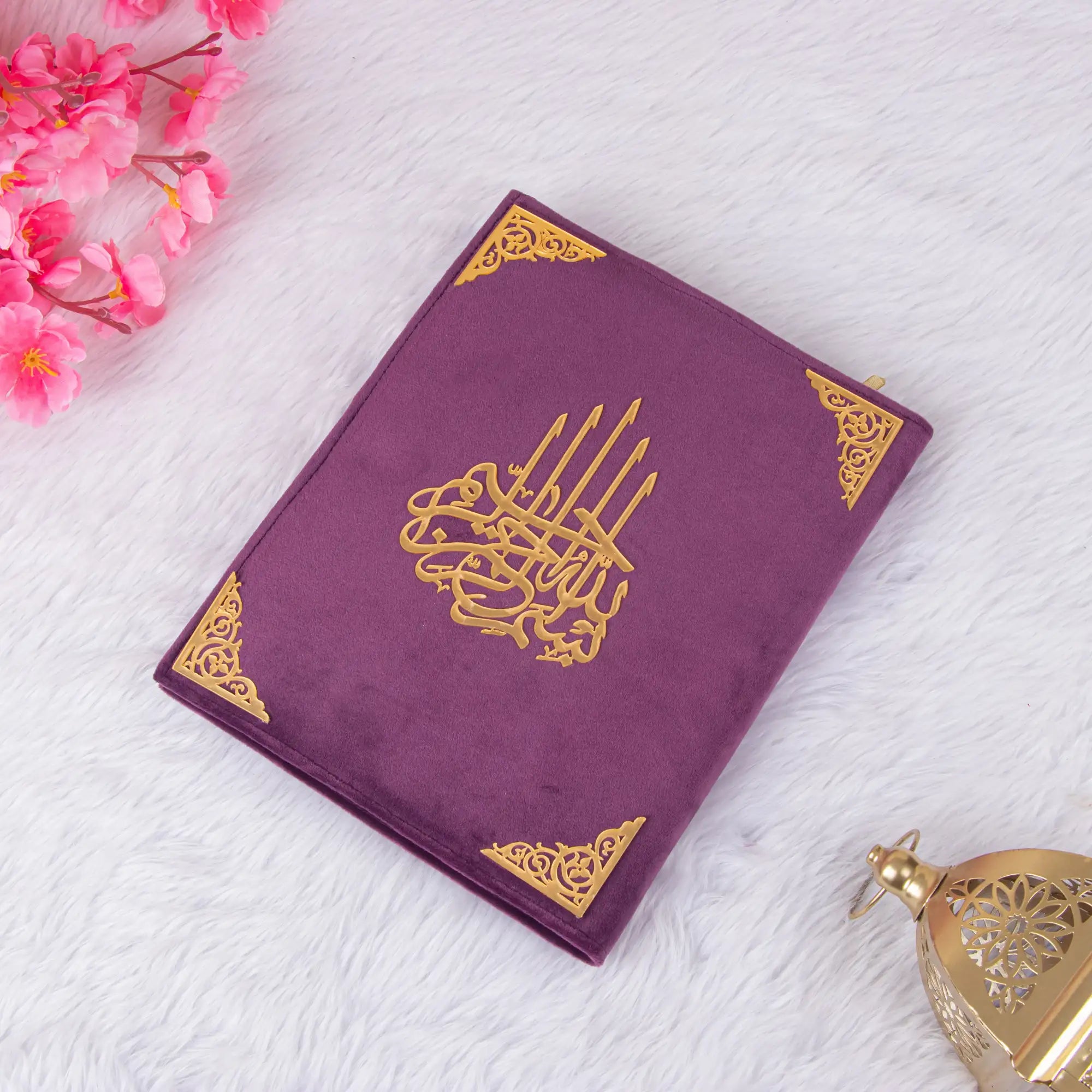 Customised Purple Salah Combo Hamper featuring a closed velvet Quran with golden Arabic calligraphy, placed on a soft white surface.