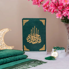 Green Salah Combo Hamper featuring premium velvet Quran, prayer rug, and tasbeeh, styled with pink flowers and crescent lamp.