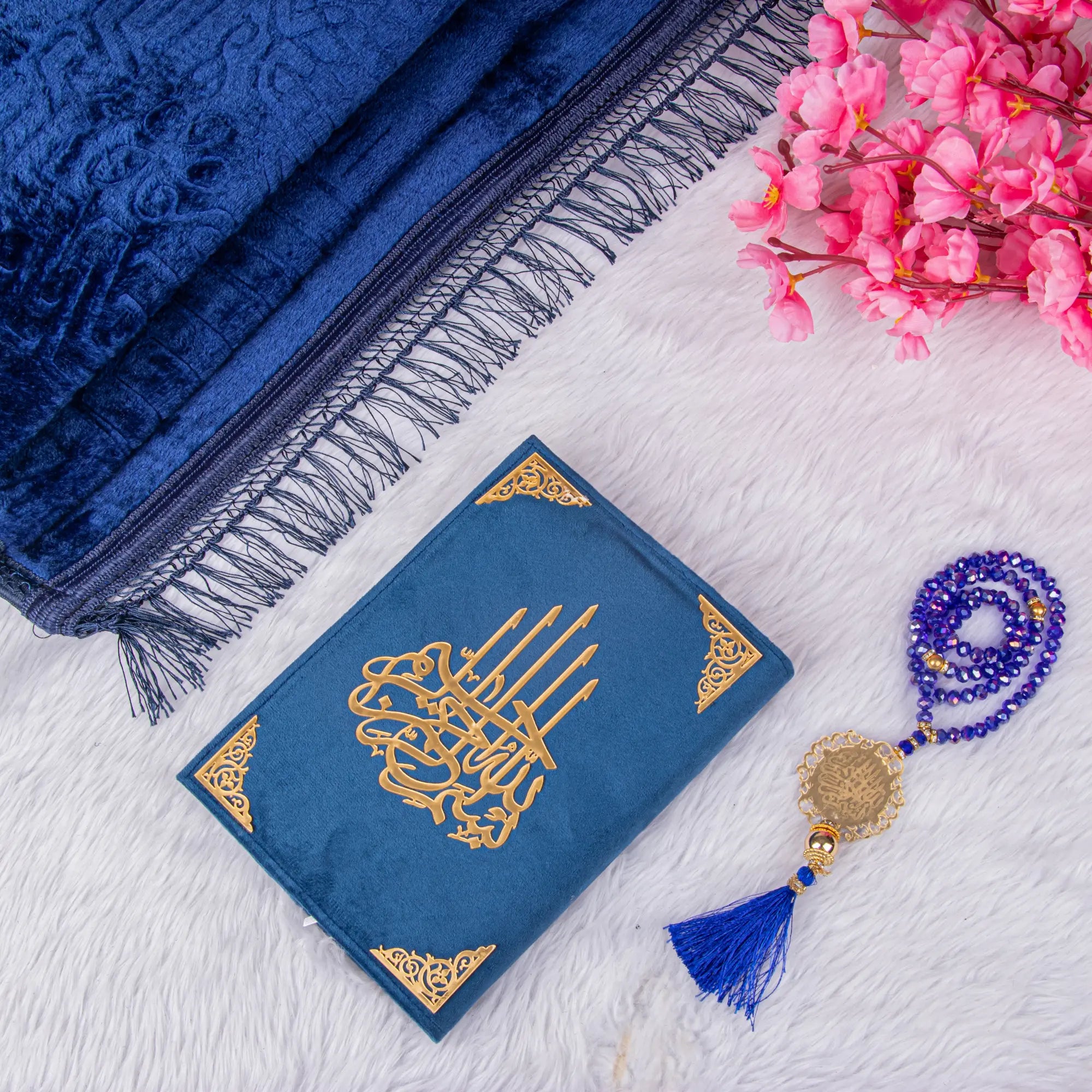 Customised Blue Salah Gift Hamper with Quran, Janamaz, and crystal Tasbeeh on white fur background. Ideal Islamic gift set for prayer rituals.