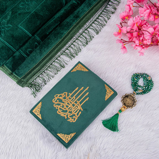 Green Salah Combo Hamper with velvet Quran, prayer mat, and crystal tasbeeh on white fur background, ideal for Islamic gifting.
