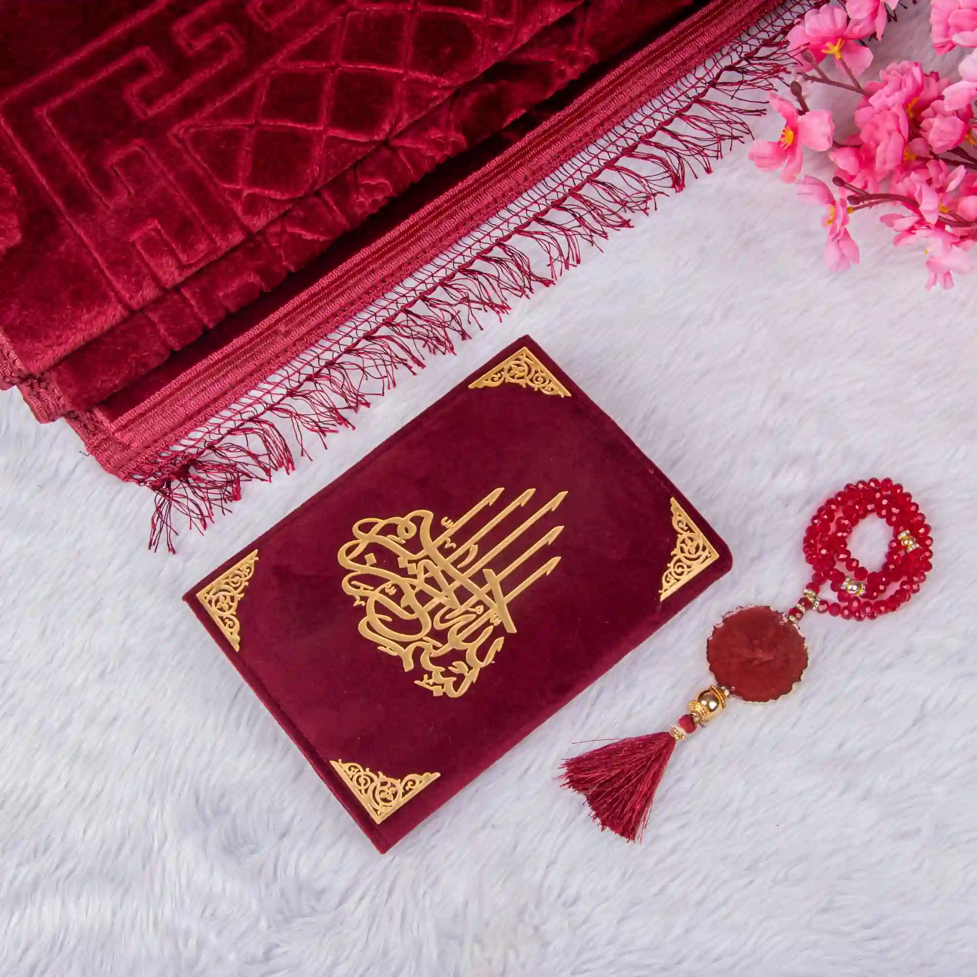 Customised Maroon Salah Combo Hamper with velvet Quran, Janamaz, and crystal Tasbeeh on white fur background. Ideal for premium prayer gifting.