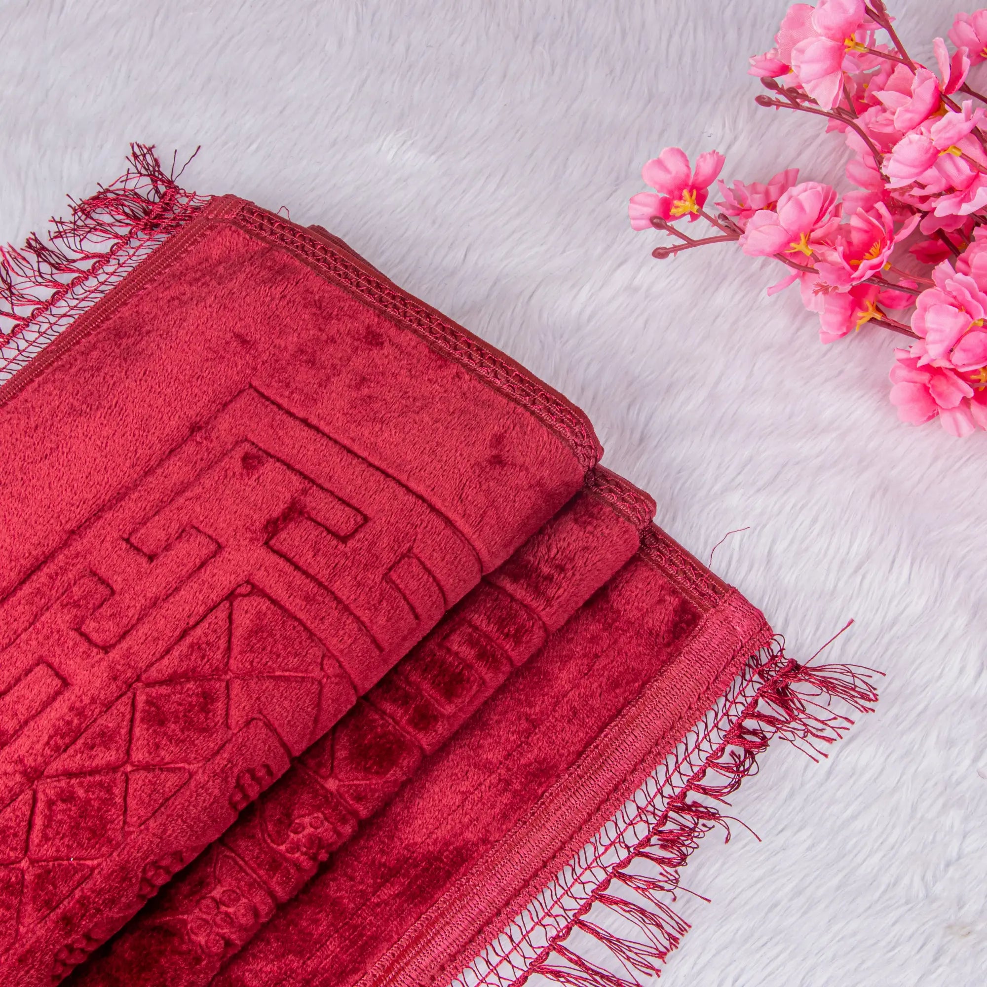 Close-up of premium maroon Janamaz from the Customised Salah Combo Hamper, showcasing intricate velvet texture and tassel edges.