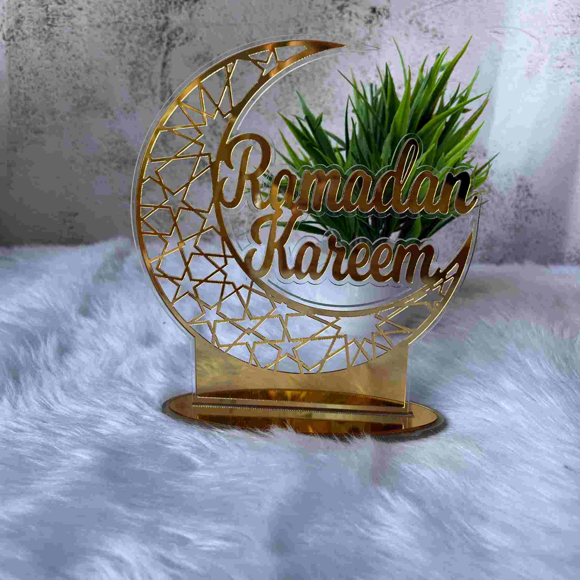 Gold Ramadan Kareem Stand for Home Decor, crescent moon design with intricate star cutouts, ideal for Ramadan & EID decorations.