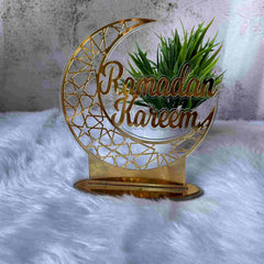 Gold Ramadan Kareem Stand for Home Decor, crescent moon design with intricate star cutouts, ideal for Ramadan & EID decorations.