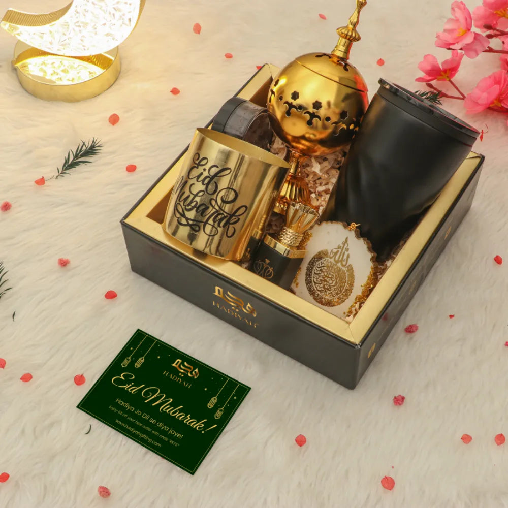 Eid Set for Husband with greeting card, gold and black gift items including candle, mug, burner, and decor in festive packaging.