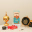 Jannah Eid Hamper - Celebrate Eid with Premium Gifts showcasing golden Bakhoor burner, black Ayatul Kursi frame, almond cookies, and caramel treats arranged for gifting.