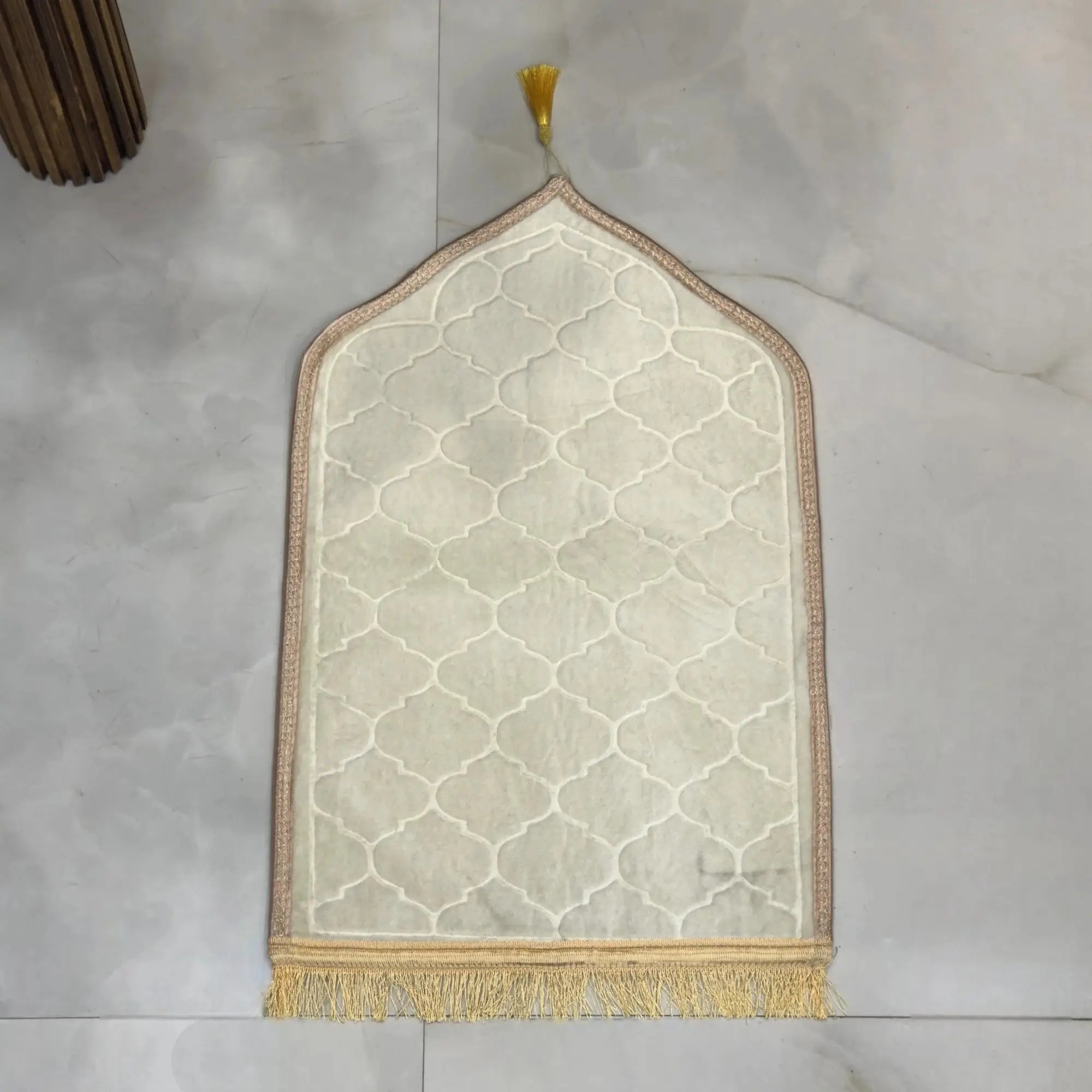 White Kids Dome Janamaz - Kids Dome Prayer Rug displayed on a marble floor, highlighting its soft texture, dome shape, and elegant tassel detailing.